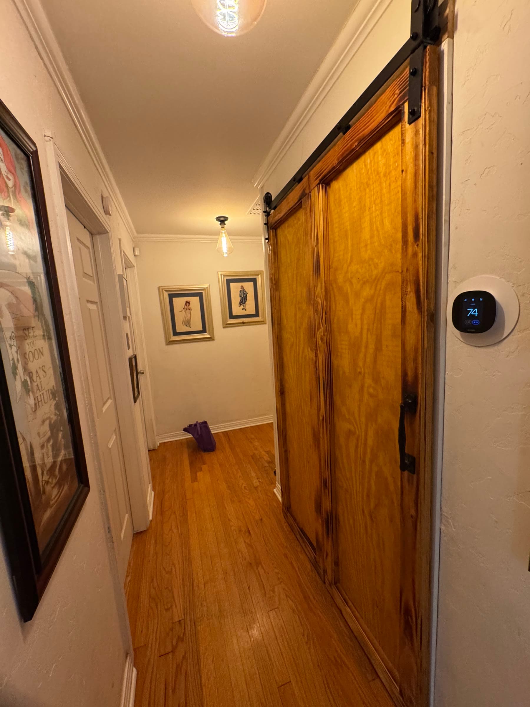 Hand-built closet doors on exposed black hardware with a hammered, torch-finished surface.