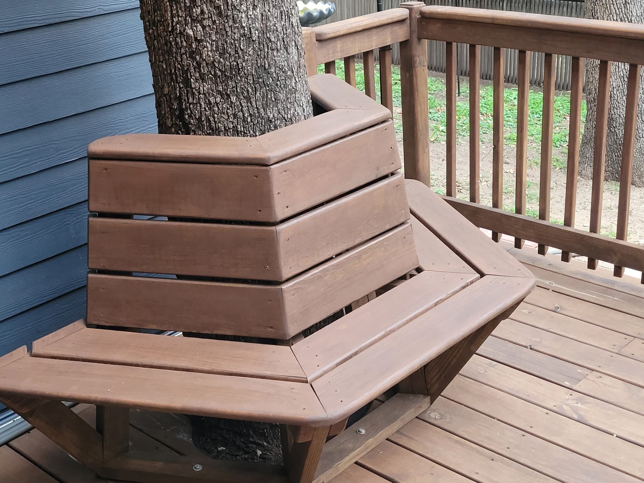 Hexagonal composite bench built around a deck tree.